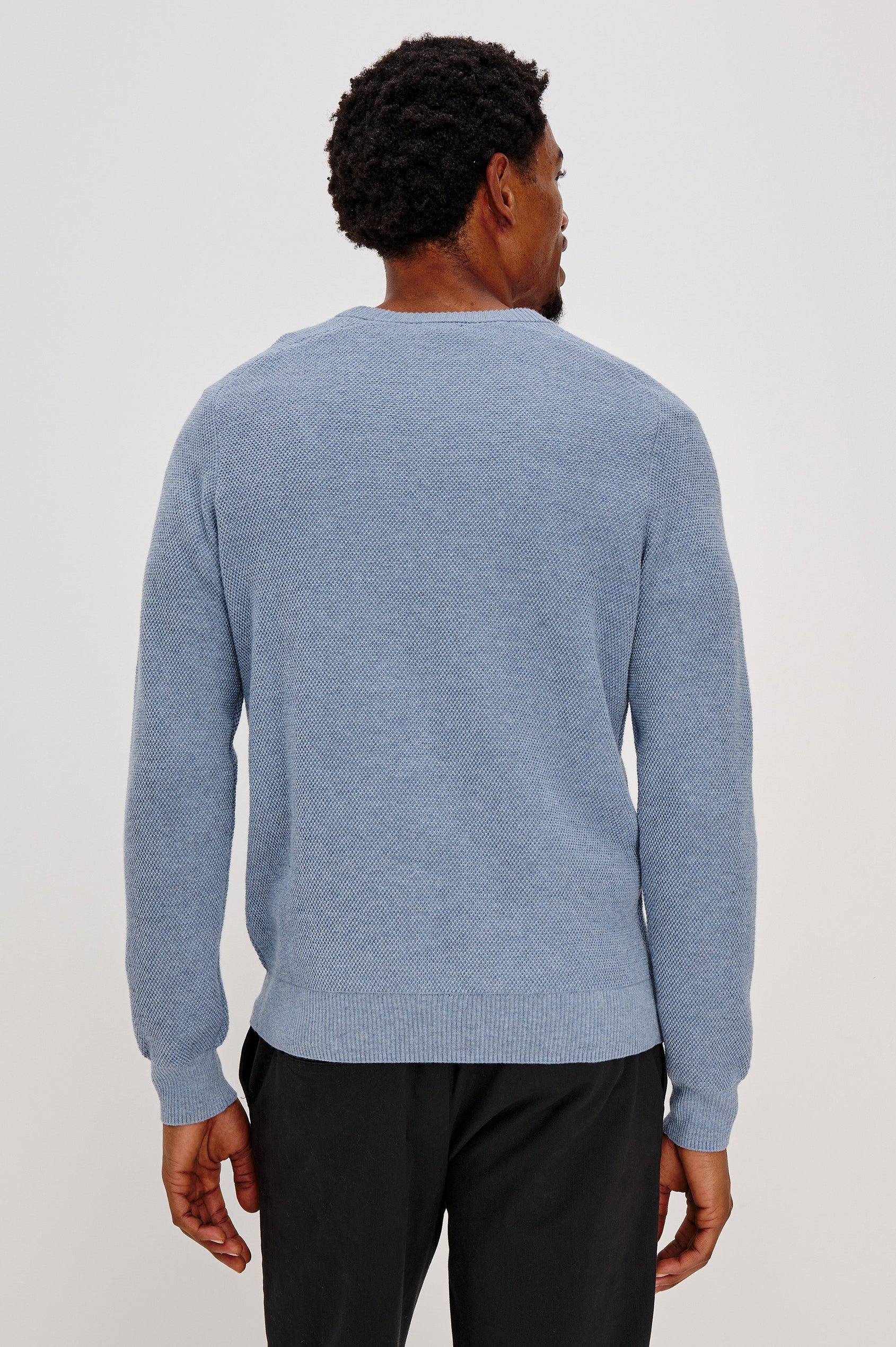 Vann long sleeve crew neck sweater in Light Blue Heather Colorway. Back View on Model Shown.
