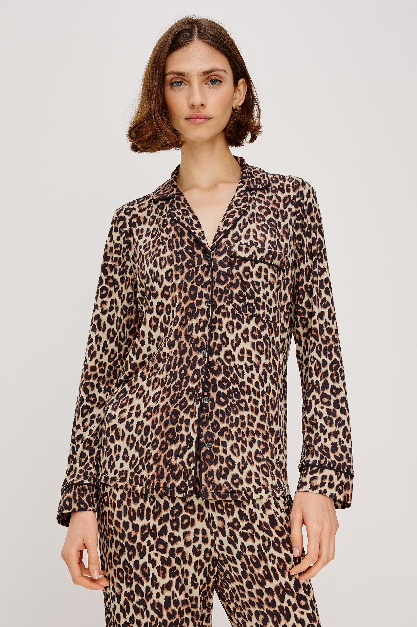 Varra Pajama Set in Jersey With Contrast Piping Button-Up Shirt With Notched Collar and Long Sleeves and Matching High-Waisted Pants With Adjustable Waist Drawstring Ties in Loose Fit in Nala Animal Print Colorway - Upper Body Front View Featured on Model