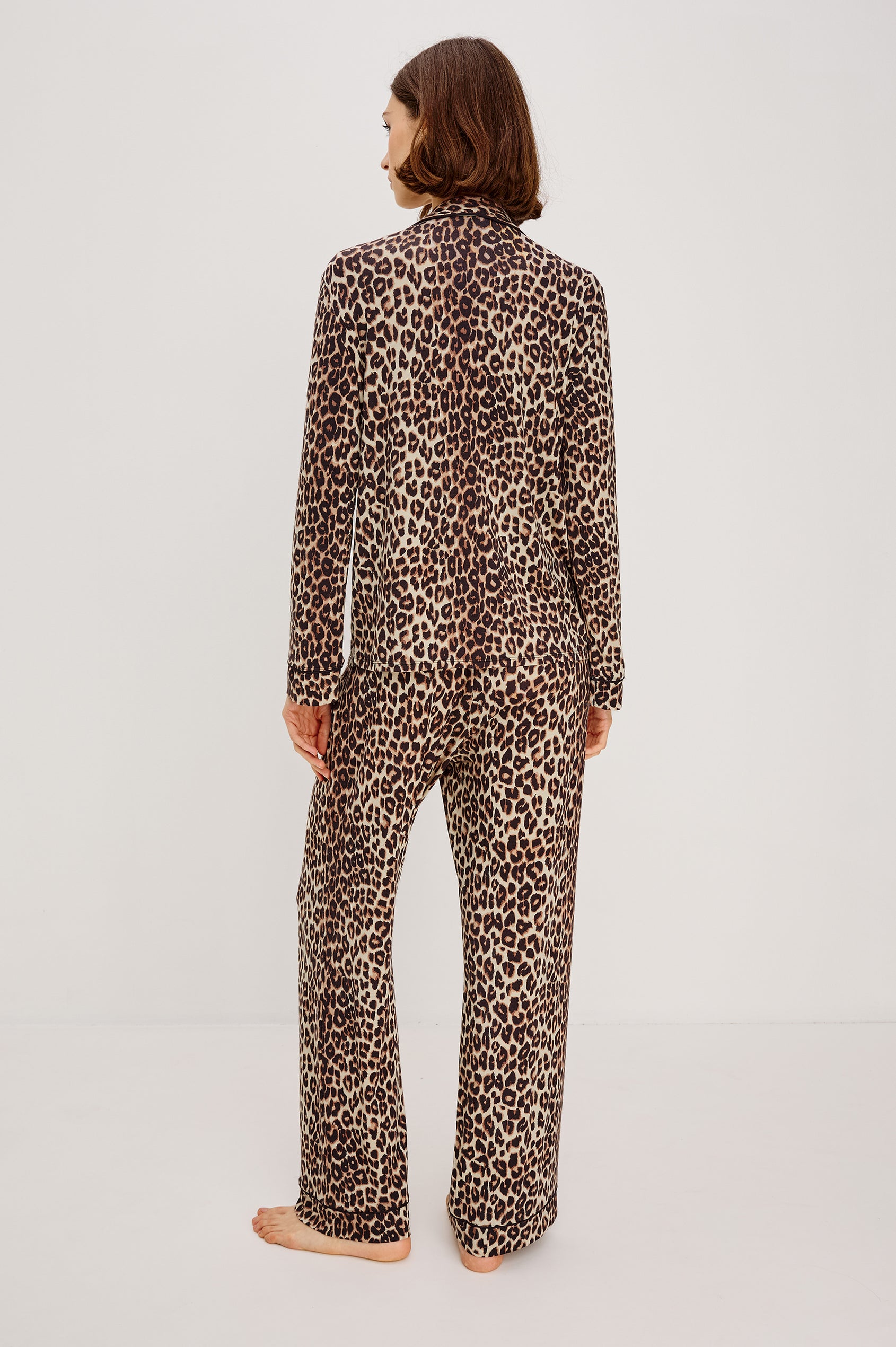 Varra Pajama Set in Jersey With Contrast Piping Button-Up Shirt With Notched Collar and Long Sleeves and Matching High-Waisted Pants With Adjustable Waist Drawstring Ties in Loose Fit in Nala Animal Print Colorway - Full Body Back View Featured on Model