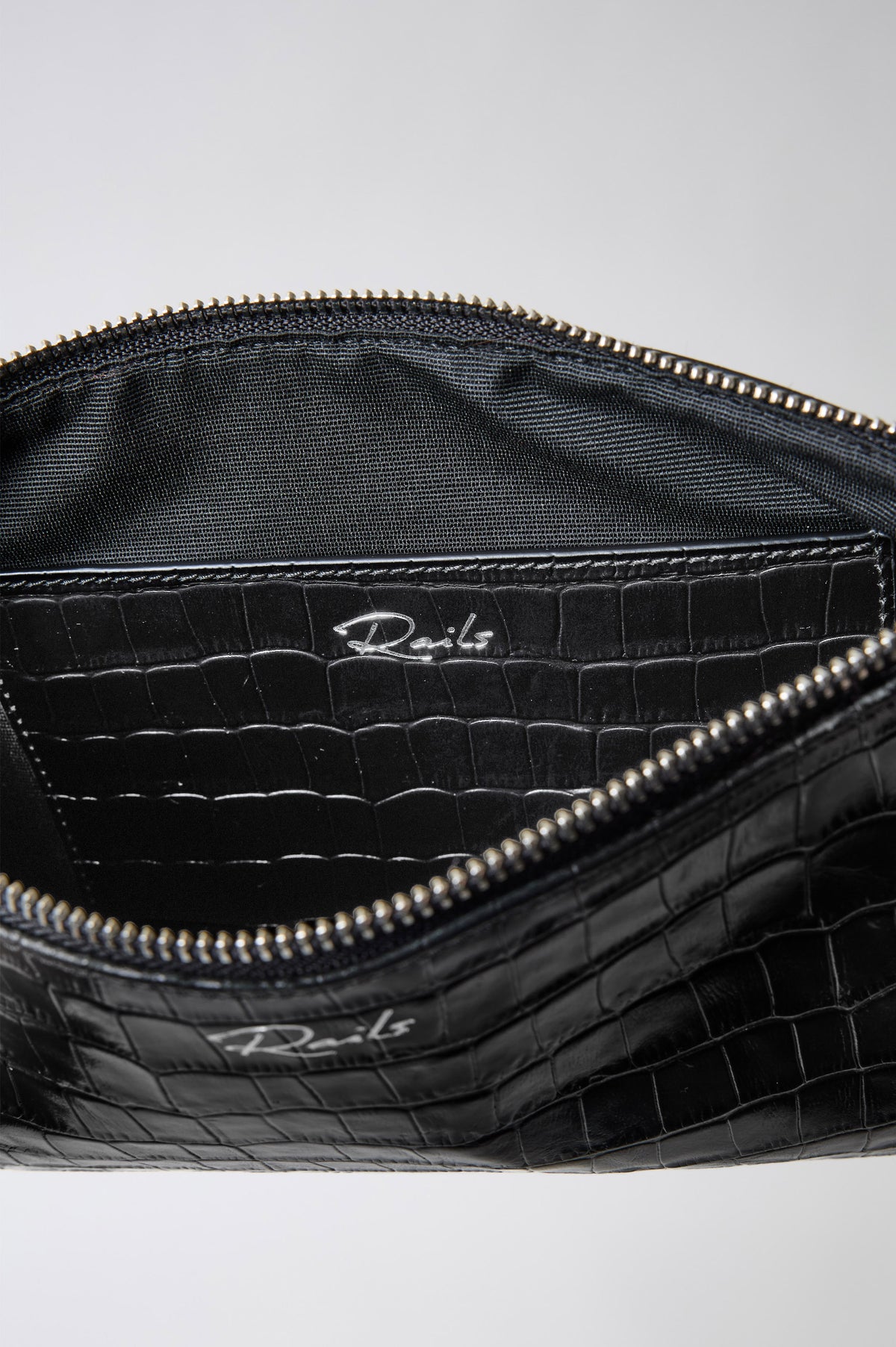 Verona Clutch Bag in Croc-Embossed Leather With Attached Wristlet Strap, Top Zip Closure, and Interior Slip Pocket in Black Croc Embossed Colorway - Close up interior product view.