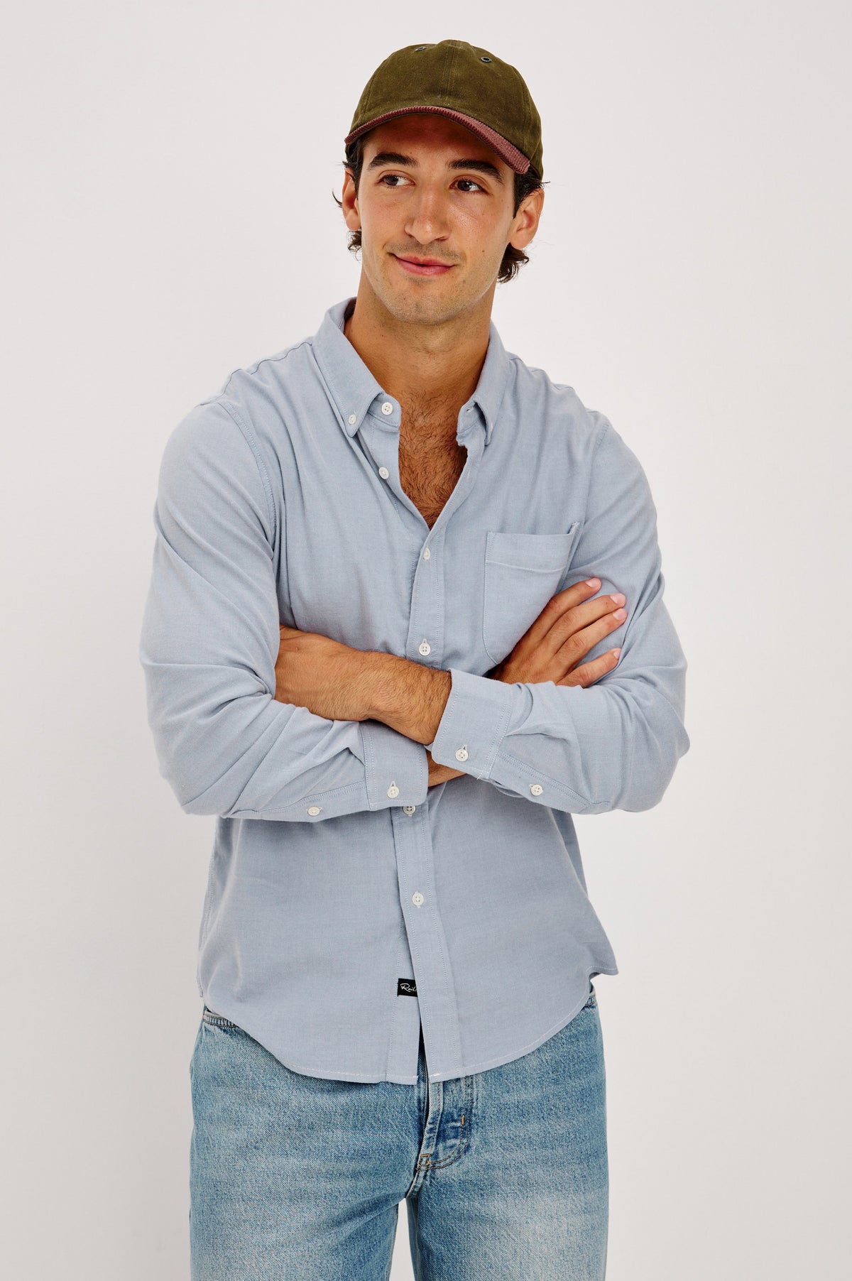 Vincent is a Collared Long Sleeve Button Front Shirt with a Chest Pocket in Blue Oxford Colorway - Front View Featured on Model.
