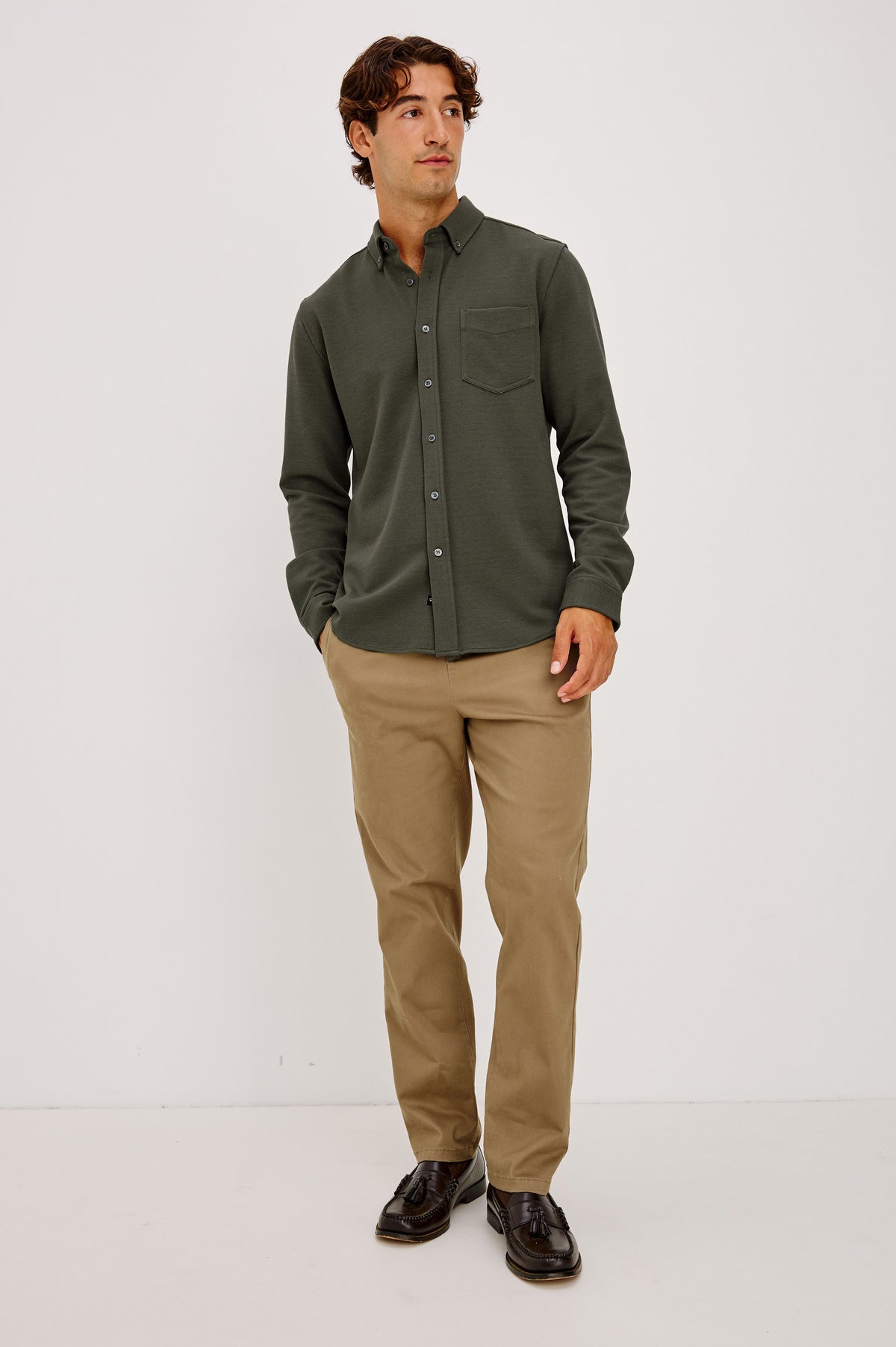 Vincent is a Collared Long Sleeve Button Front Shirt with a Chest Pocket in Hunter Green Colorway - Full Body Front View Featured on Model.