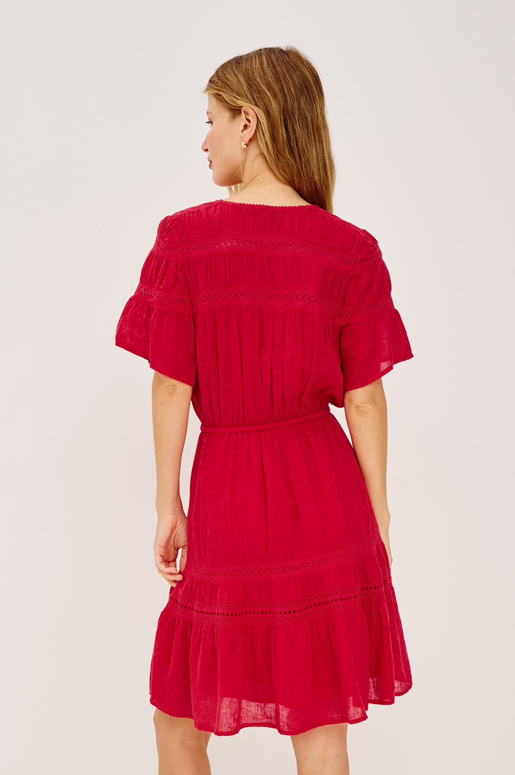 Winslow Mini Dress in Luxe Linen With Loose Fit, Lace Insets, Partial Button Front, Adjustable Drawstring Waist Ties, and a Fully Lined Skirt in Tomato Colorway - Upper Body Back View Featured on Model