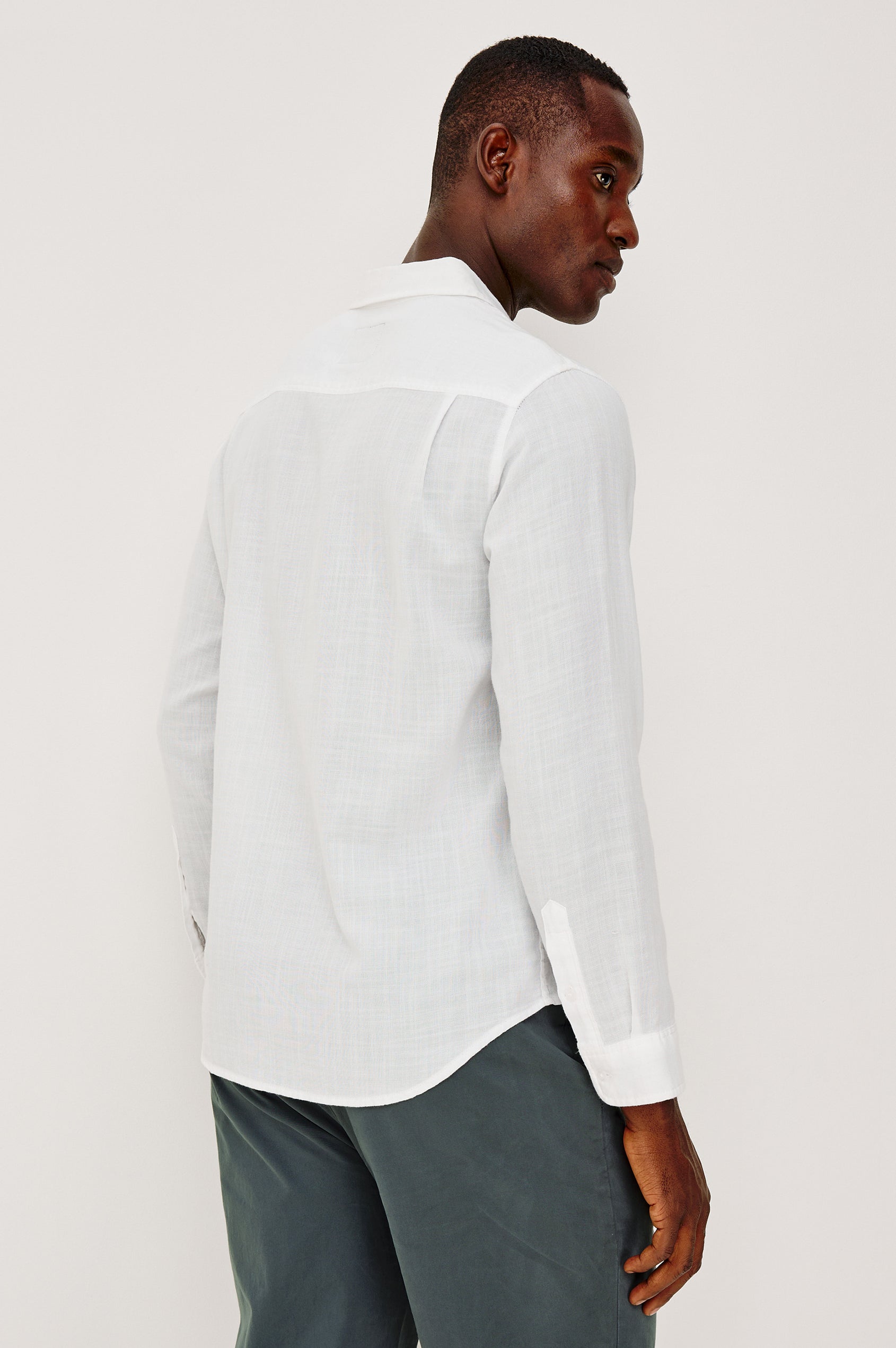 Wyatt Button Front Collared Shirt With Long Sleeves and Single Chest Pocket in White Colorway - Upper Body Back View Featured on Model