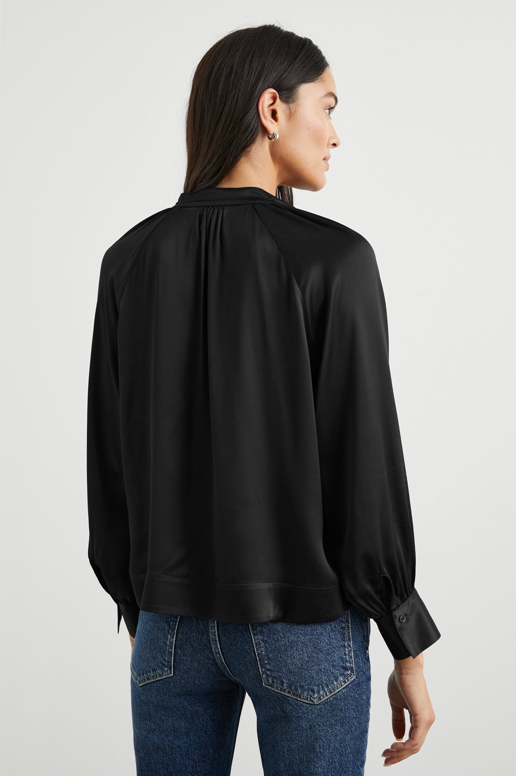 Wynna Long-Sleeve Top with a Deep V Neck and Ruching above the Cuffs and at the Neckline in Black Colorway - Back View Featured on Model
