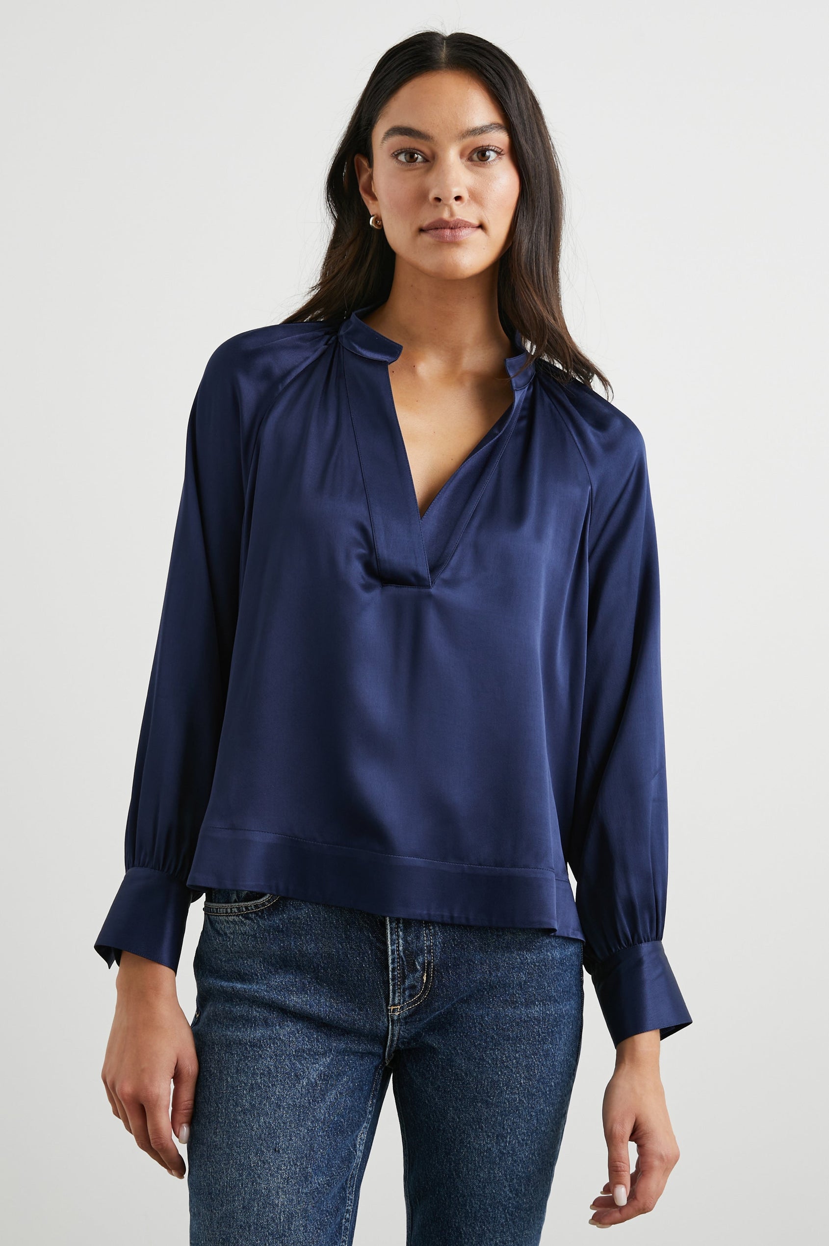 Wynna Long-Sleeve Top with a Deep V Neck and Ruching above the Cuffs and at the Neckline in Navy Colorway - Front View Featured on Model