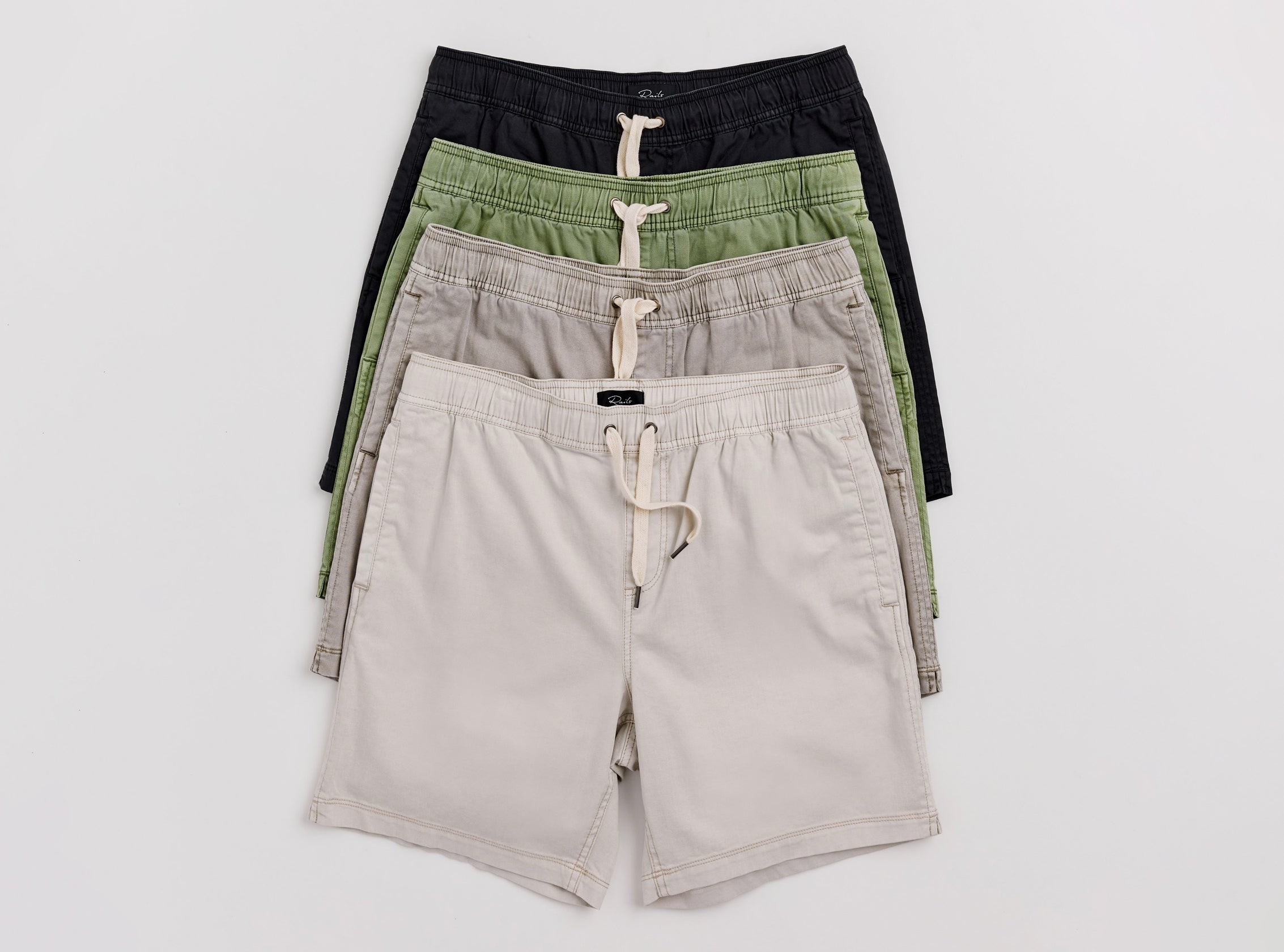 4 pairs of different colored shorts on a white background