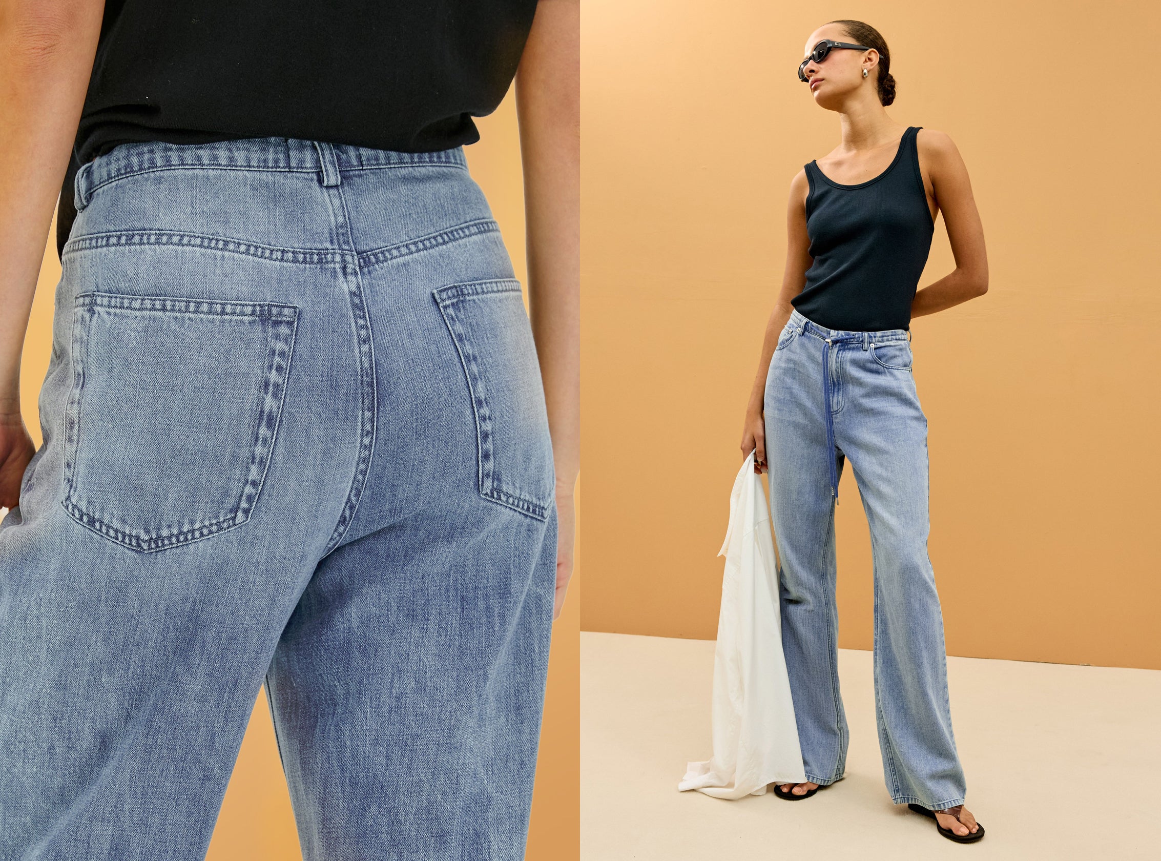 Woman wearing light blue jeans with a plain background