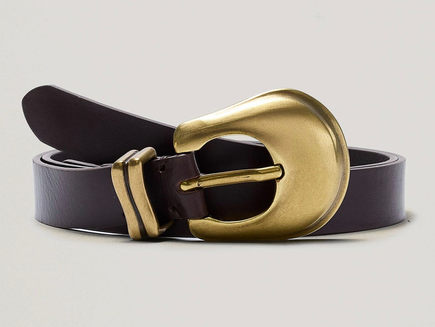 Brown belt with a gold buckle on a light gray background