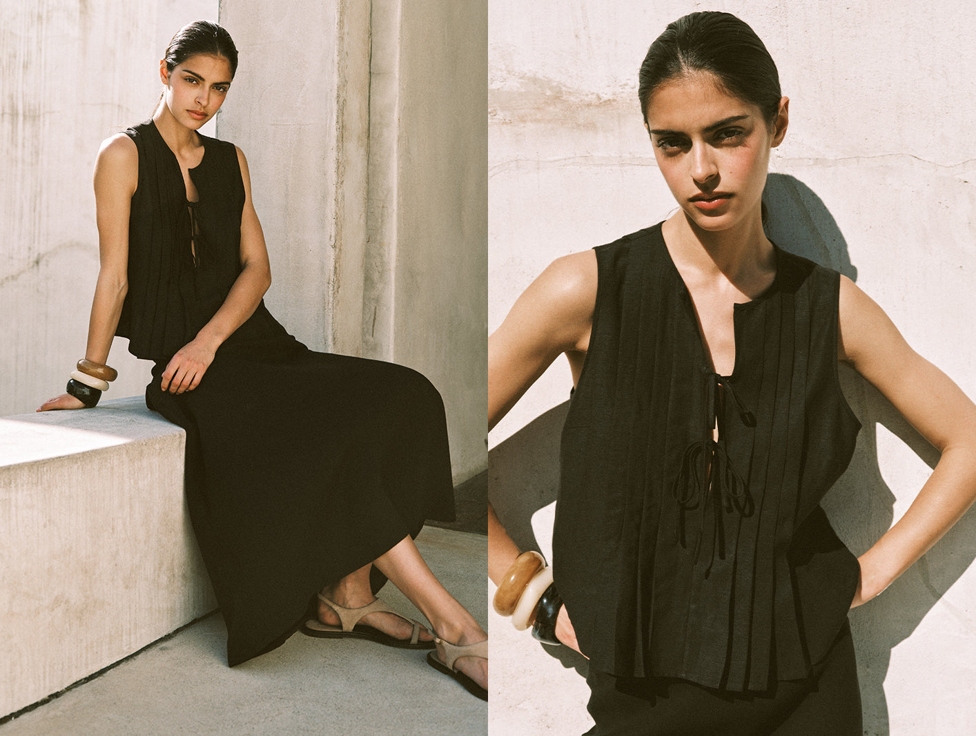 Woman wearing a black sleeveless dress sitting on a stone bench.