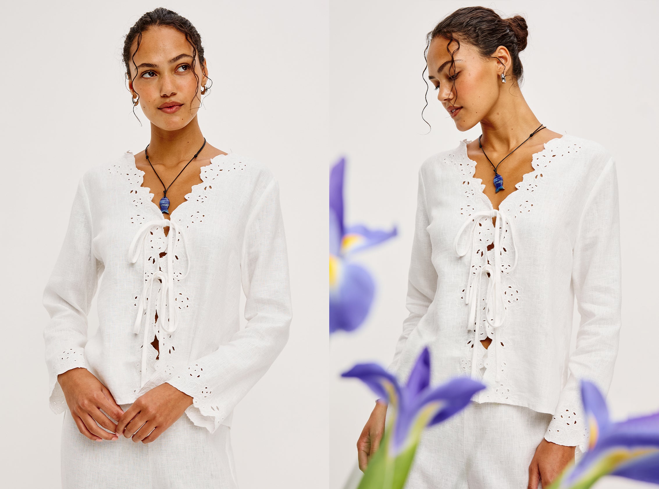 Woman wearing a white blouse with lace details against a white background