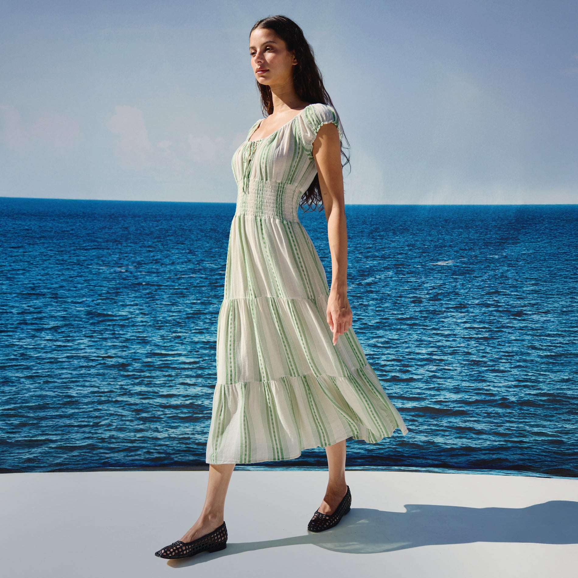 Woman wearing a green and white striped dress