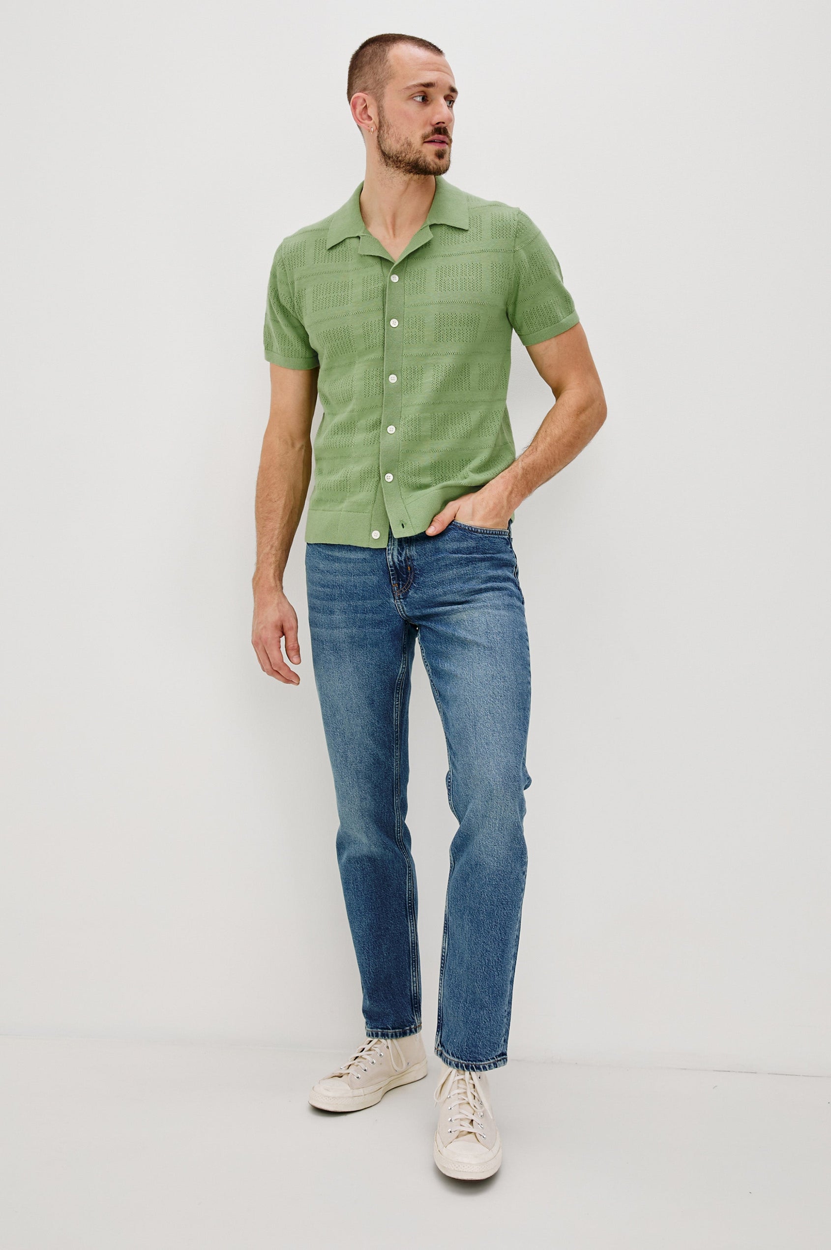 Yates Button Front Knit Shirt with Short Sleeves, a Relaxed Collar and Lapel, Ribbed Sleeve Cuff, Collar, Hem and Front Button Placket in Cream Colorway. Full Body Front View Shown on Model.