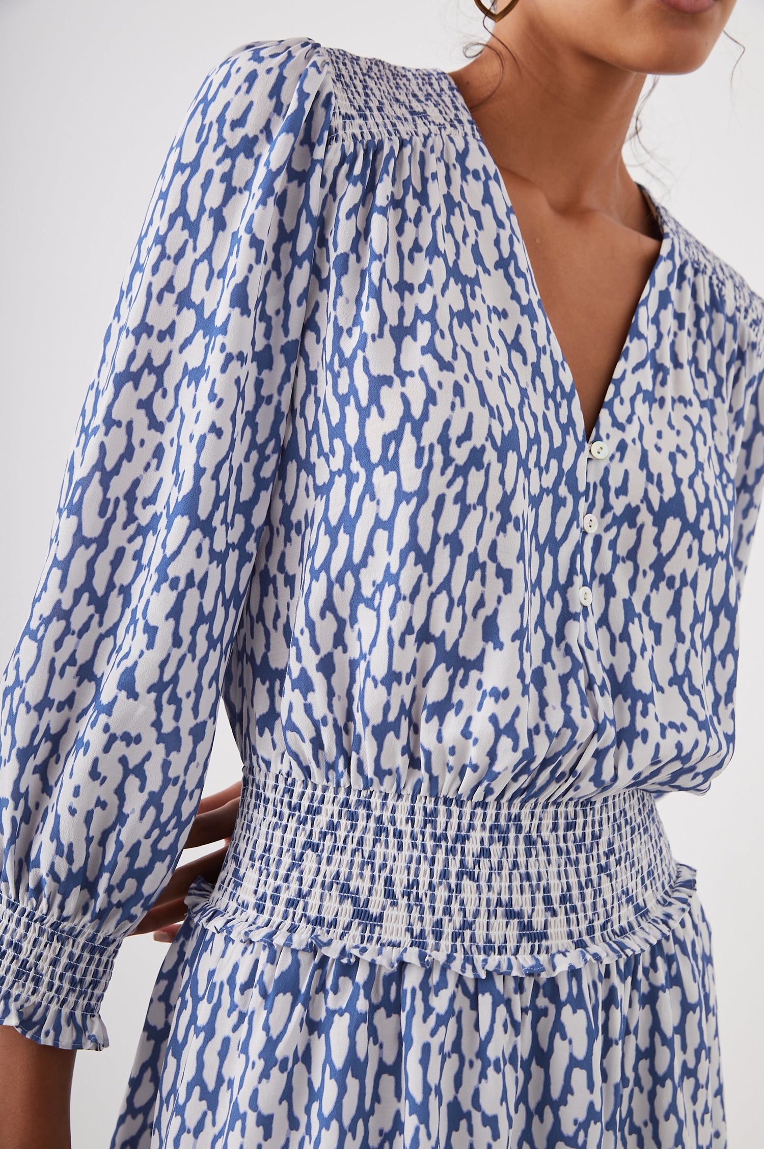 Zana Long-Sleeve Mini Dress with a V Neck, Smocked Cuffs and Waist, and Buttons Down the Bodice in Cobalt Static Leopard Colorway, a White and Cobalt Spotted Print - Front View Featured on Model