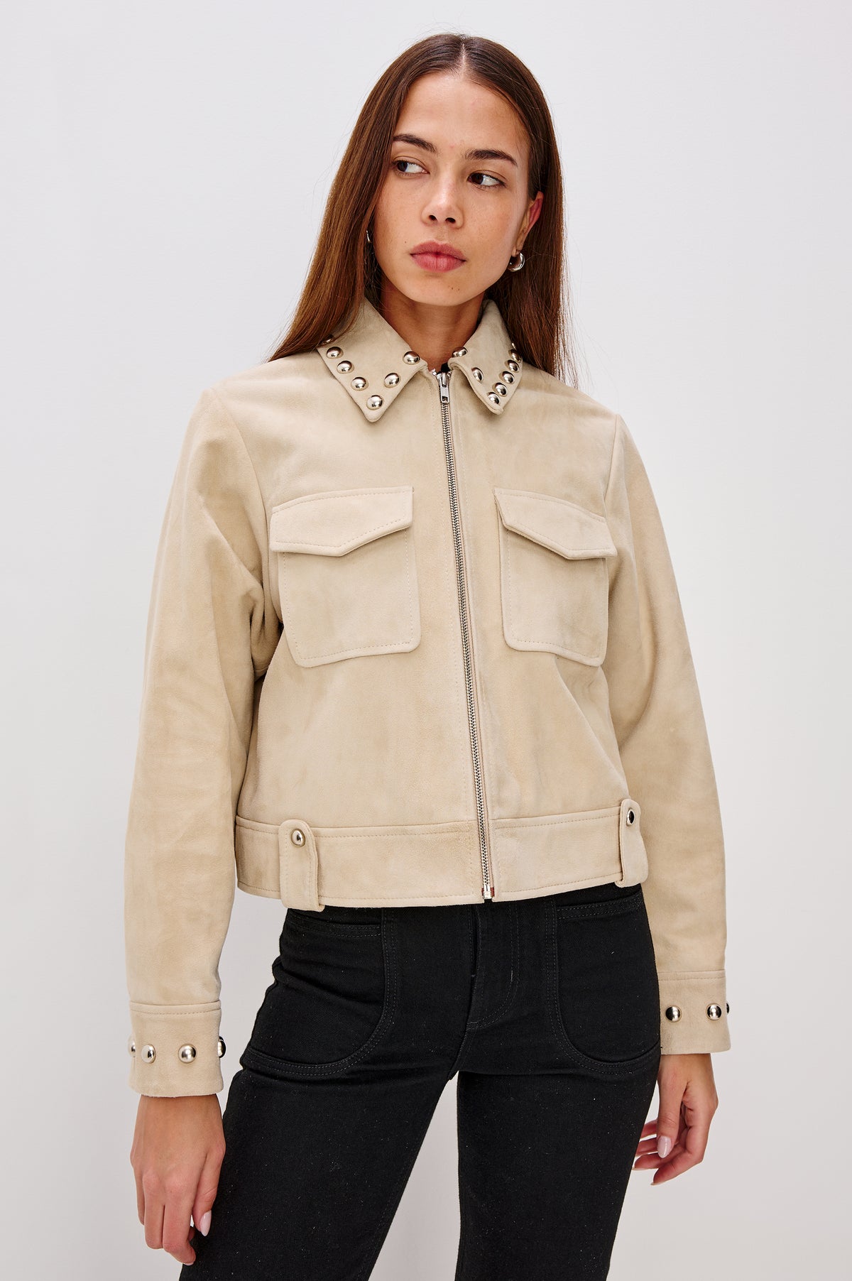 Zeta Boxy Moto Jacket in Suede With Metallic Studs, Collar, Front Zip Closure, Chest Flap Pockets, and Long Sleeves in Taupe Colorway - Full Body Front View Featured on Model