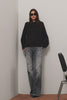 Alamitos Flared Trouser in Comfort Stretch Denim With High-Rise Relaxed Fit, Wide Legs, and 5-Pockets in Night Rider Colorway - Full Body View Featured on Model Posing with Chair (Video).
