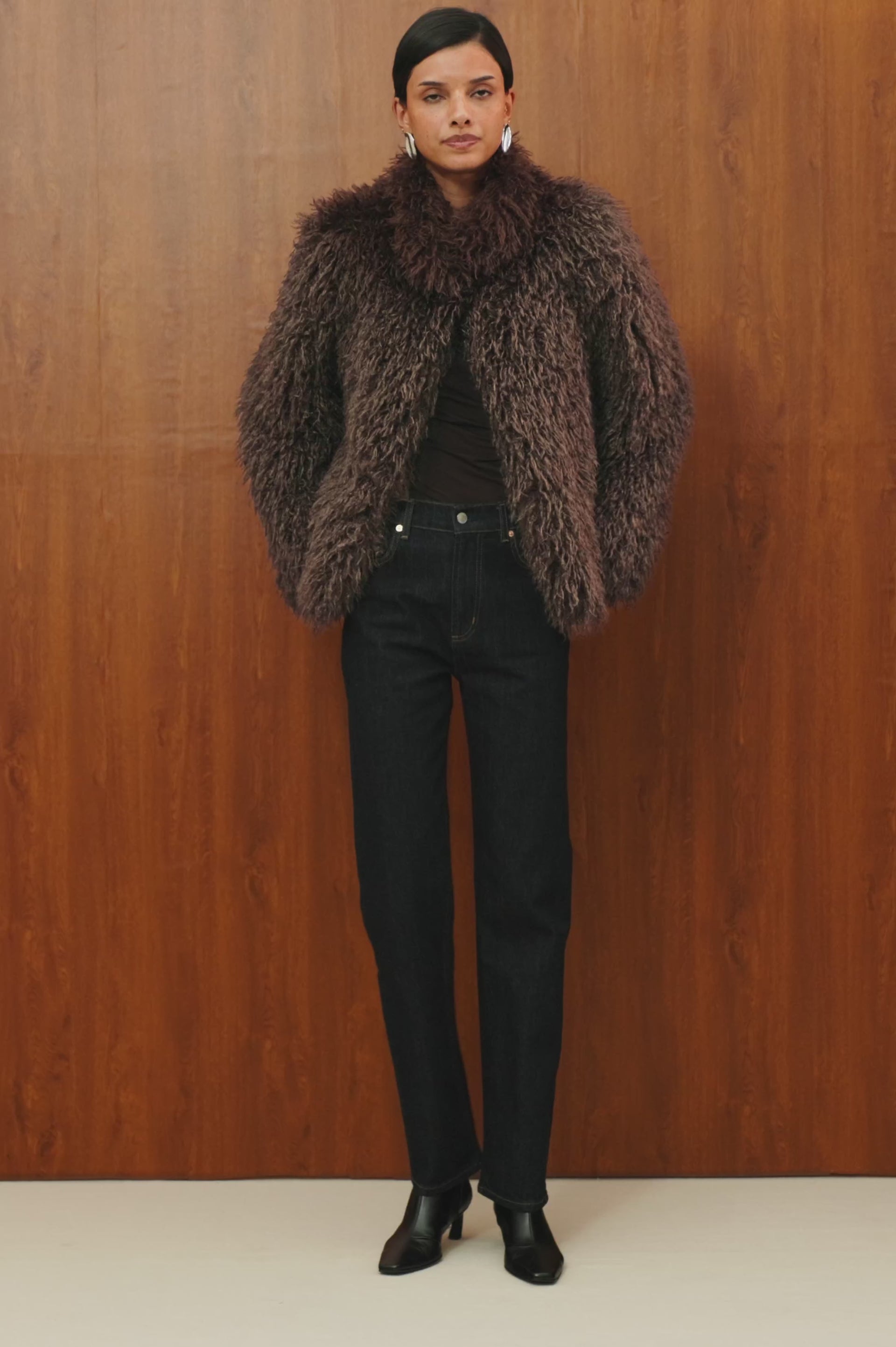 Blisse Jacket in Faux Mongolian Fur With Boxy Slightly Cropped Cropped Silhouette, Collar, Satin-Like Lining, Side Pocketts, and Front Hook-And-Eye Closure in Espresso Colorway - Full Body Front View Featured on Model - Video