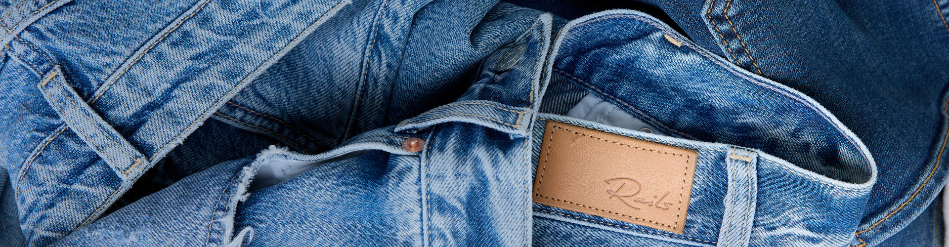 Close-up of blue denim jeans with a leather label.